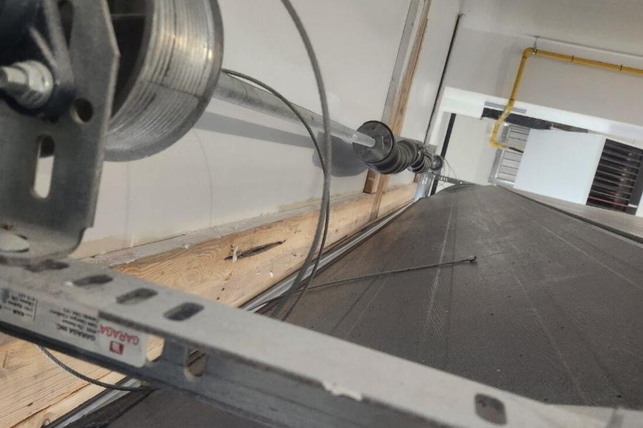 DPS Garage Doors repairing a garage door lifting cable at the cable drum on the torsion shaft in the GTA